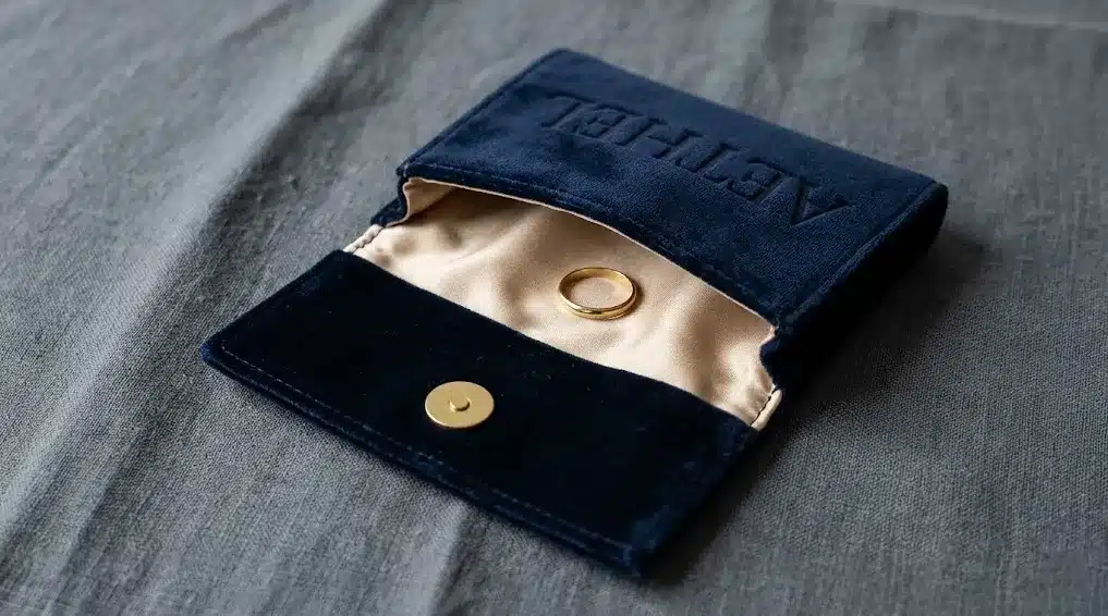 Navy Velvet Snap Flap Jewelry Pouch Open Showing Interior and Snap Closure Blog Deep navy velvet flap pouch photographed half-open showing the snap closure hardware and soft interior lining with a ring inside