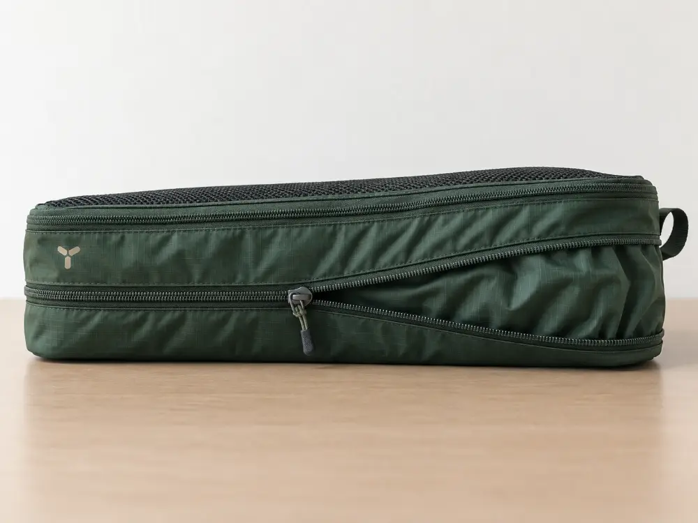 Compression Packing Cube Zipper Structure Forest green compression packing cube with a mesh top panel, expansion section and secondary zipper