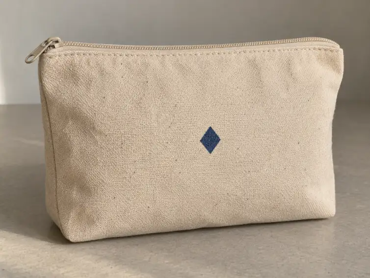 Custom Travel Bag Logo Placement Beige canvas travel pouch with a simple centred printed logo mark
