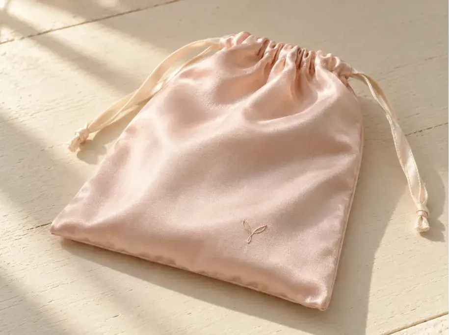 Soft Branding Placement on a Premium Lingerie Gift Pouch Pale satin lingerie gift pouch with a small abstract non-text emblem